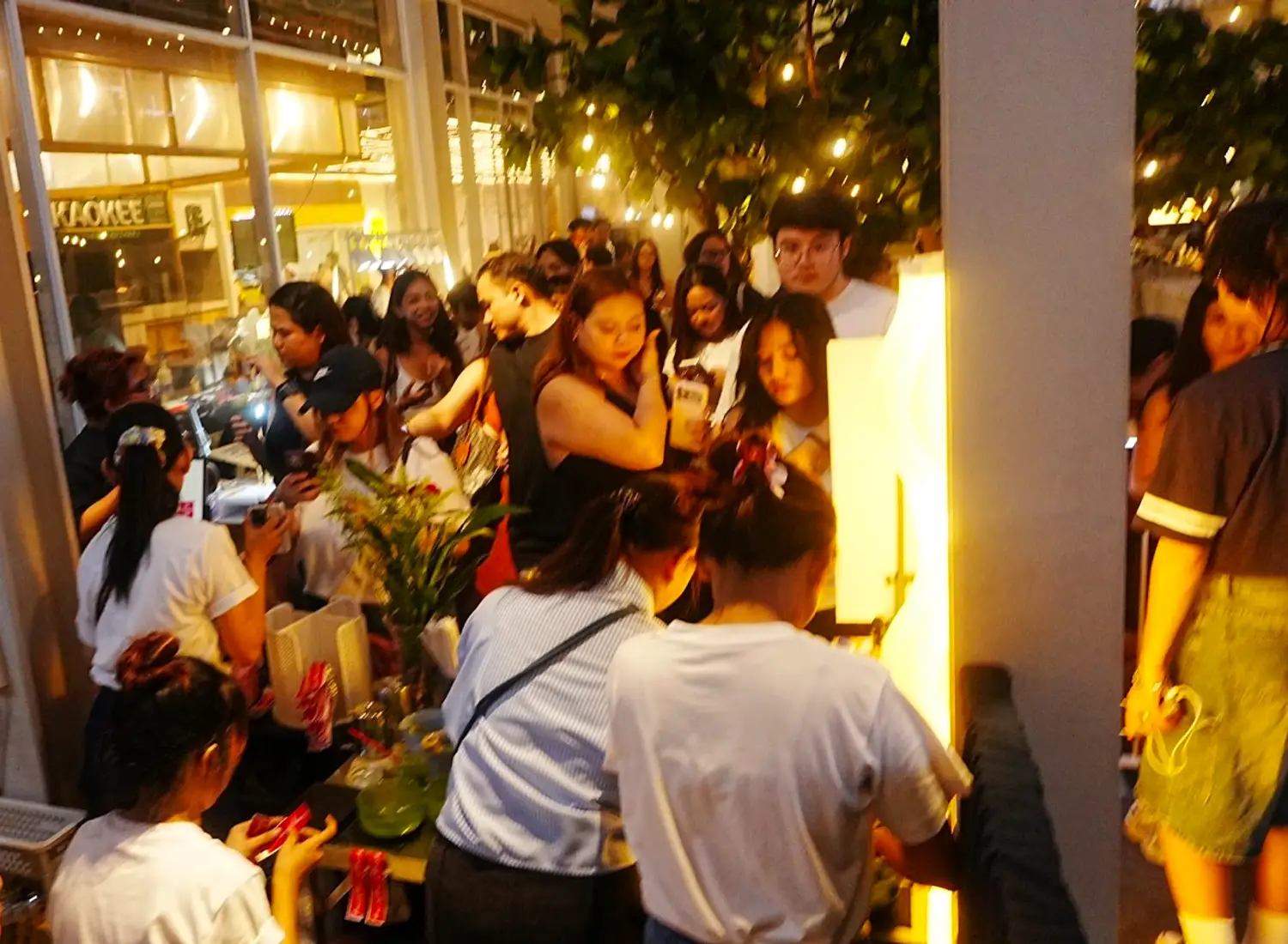 Guests mingling at a Cabana Club night event under garden lights