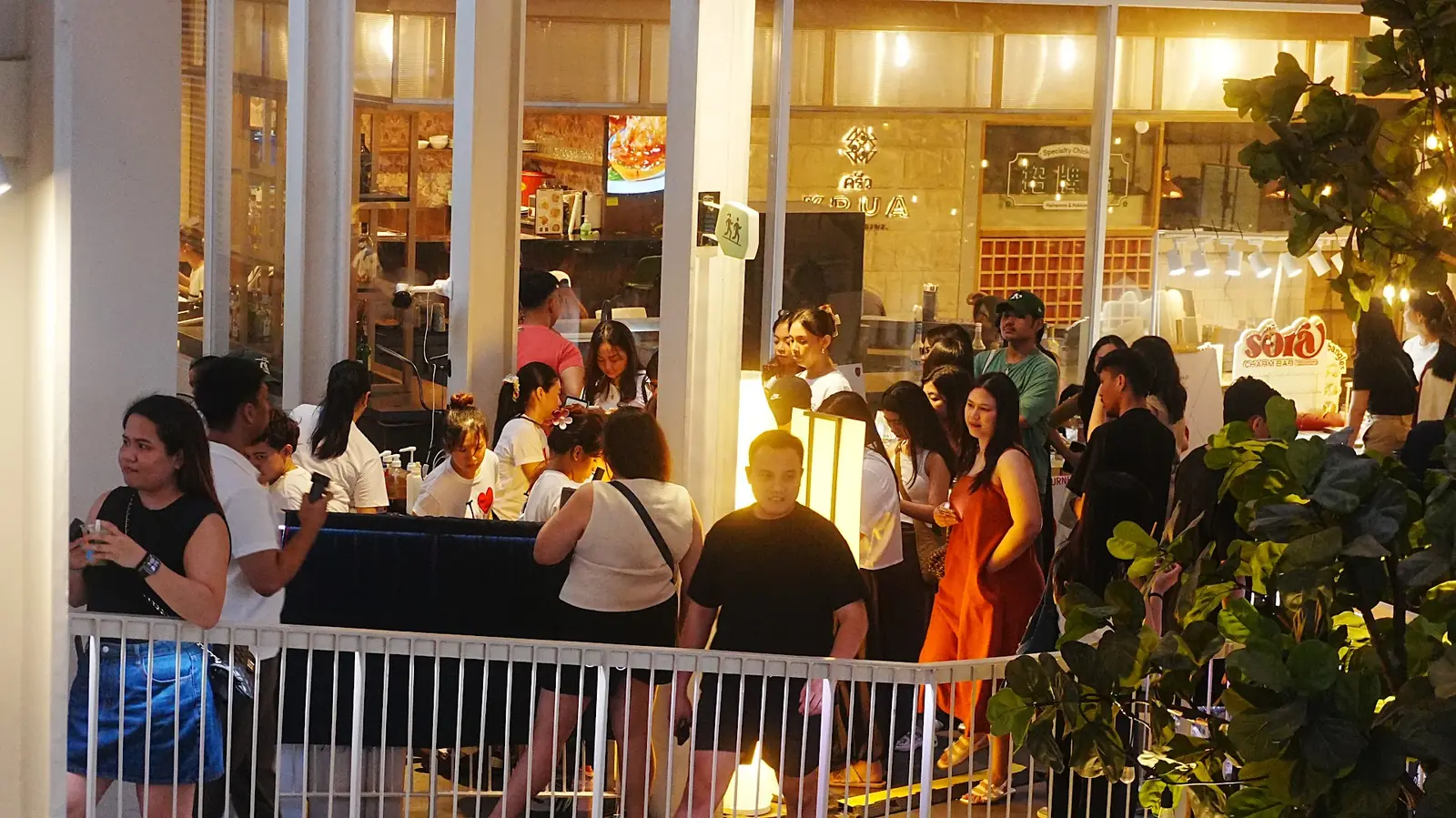 Night-market crowd at a Cabana Club event under warm string lights